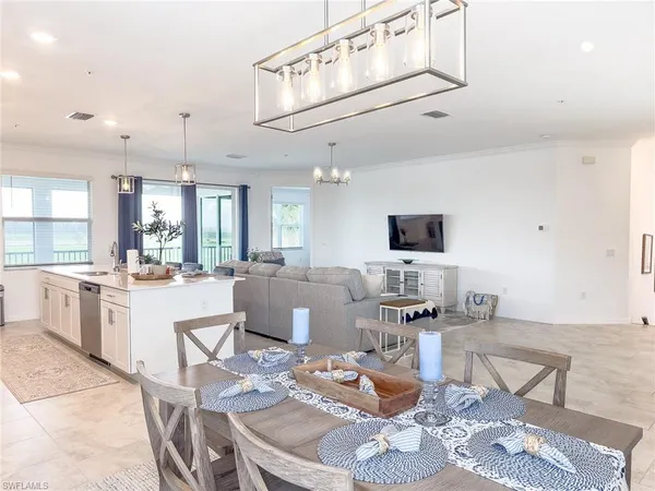a view of a dining room that has a table chairs and a wooden floor
