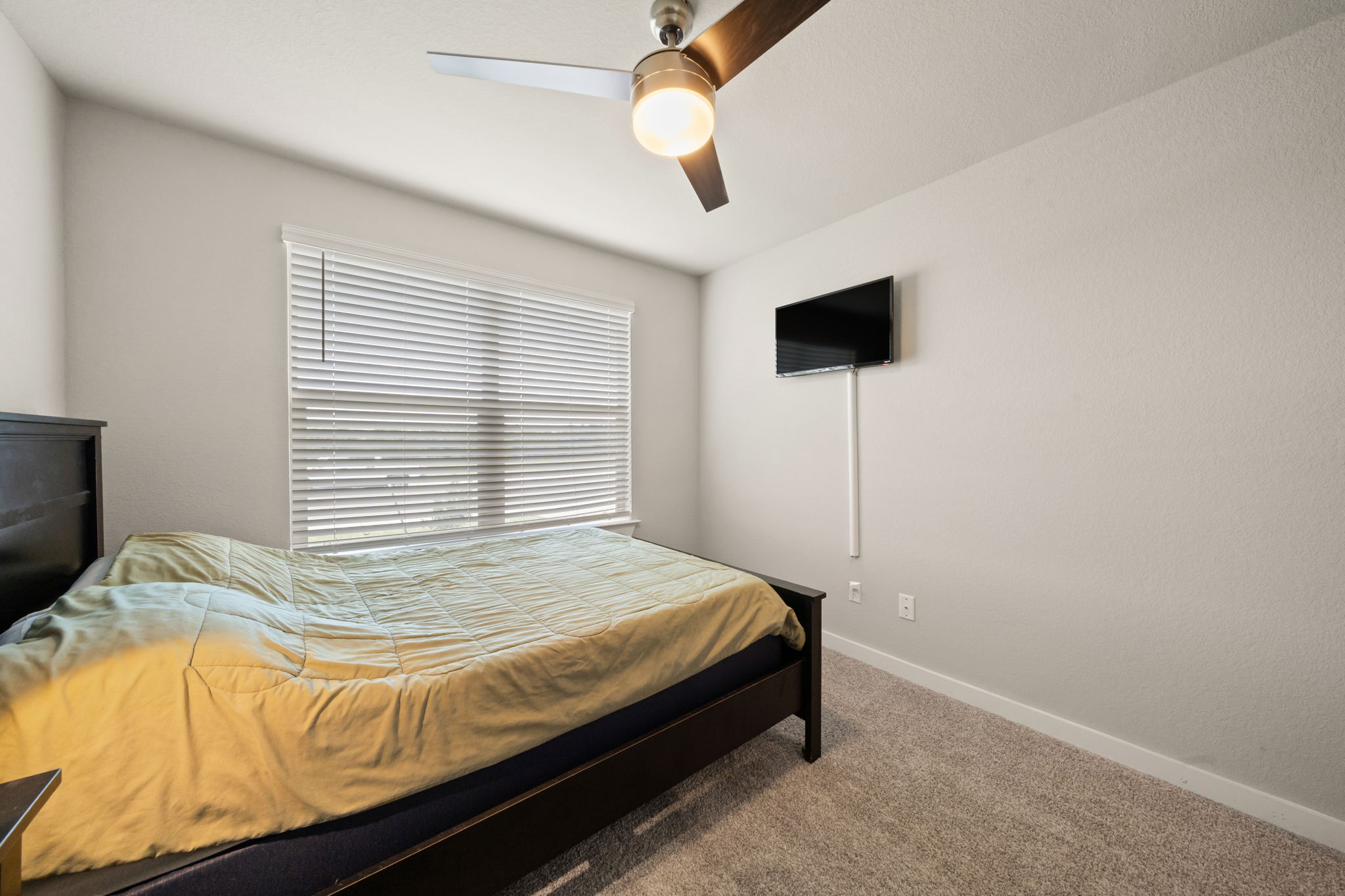 1117 Tipton Street Georgetown, TX 78633 - Photo 28 of 40 Carpeted room with a ceiling fan featuring a light kit, a large window with horizontal blinds, and neutral wall paint