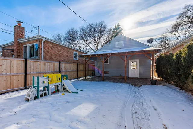 a view of a house with large outdoor space and sitting area