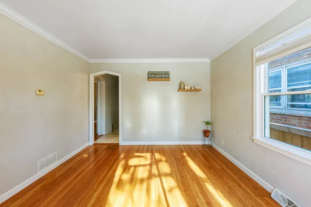 a view of a room with wooden floor and natural light