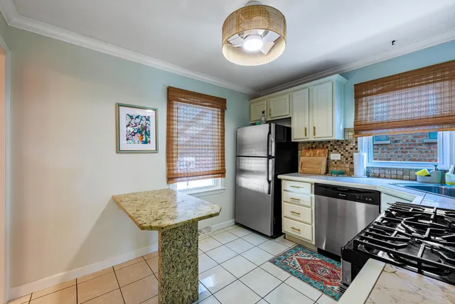 a kitchen with stainless steel appliances granite countertop a stove and a refrigerator