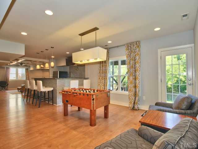 1817 Wescott Drive Raleigh, NC 27614 - Photo 18 of 25 Awesome rec room area in basement with access to the backyard and wet bar. Basement