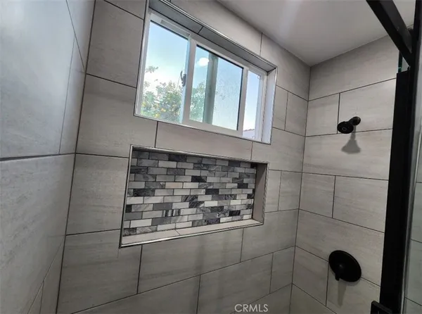 a bathroom with a shower and a sink