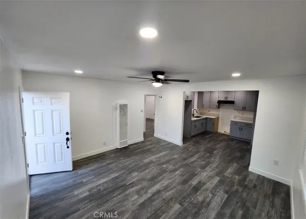 a view of a kitchen with a sink and a refrigerator