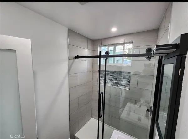 a bathroom with a glass shower door