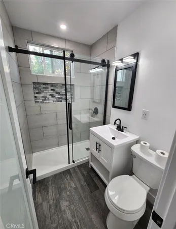 a white toilet sitting next to a bathroom sink