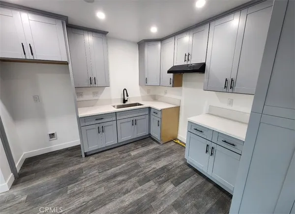 a kitchen with a sink stove and cabinets
