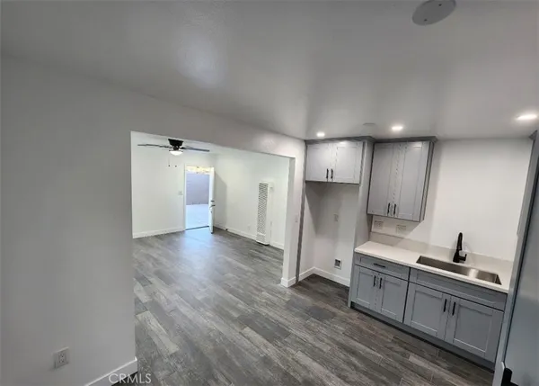 a view of a kitchen with a sink and refrigerator