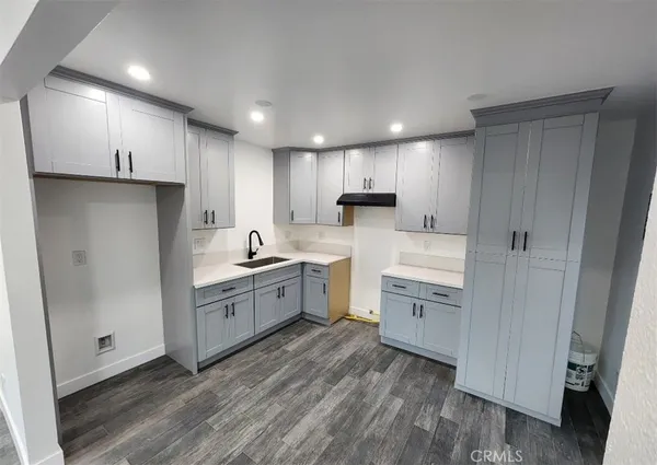 a kitchen with white cabinets and white appliances