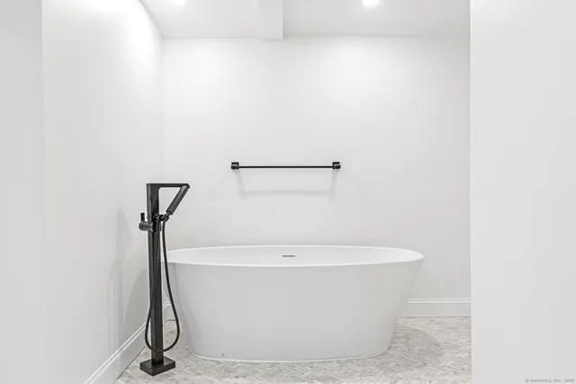 a white bath tub sitting in a bathroom