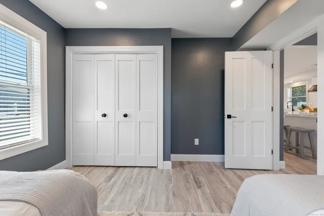 a bedroom with a bed and a painting on the wall