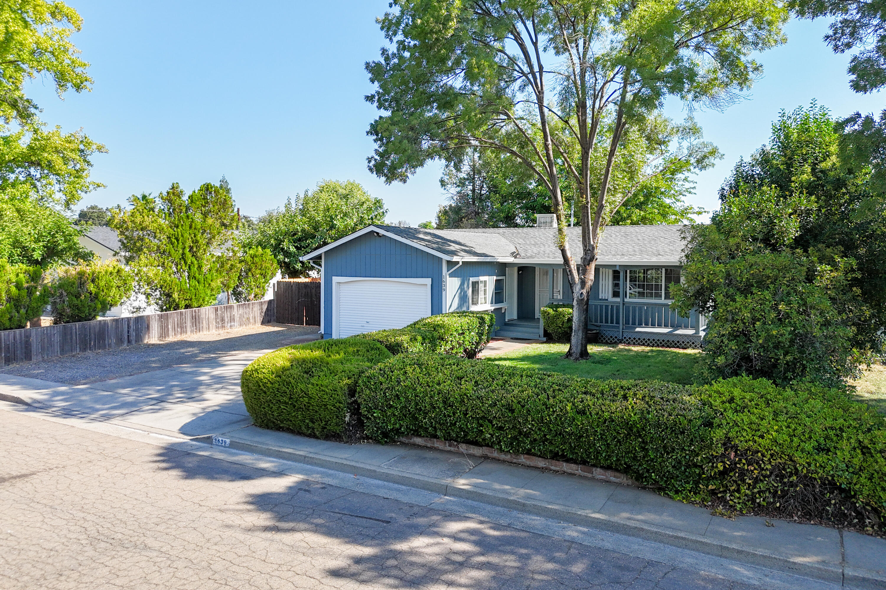 a front view of a house with a garden