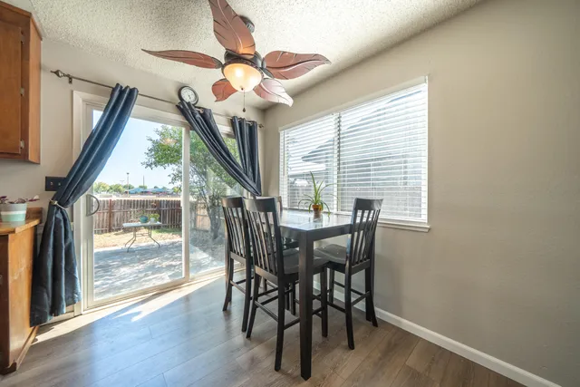 a view of a dining room with furniture wooden floor and chandelier