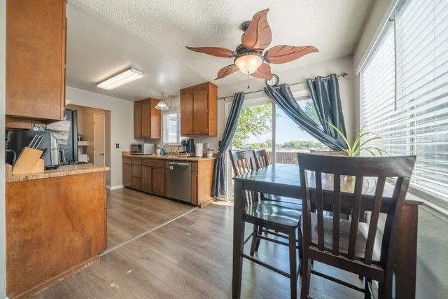 a view of kitchen with furniture and a ceiling fan