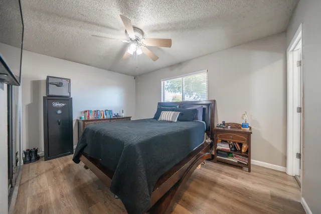 a bedroom with a bed and a chandelier