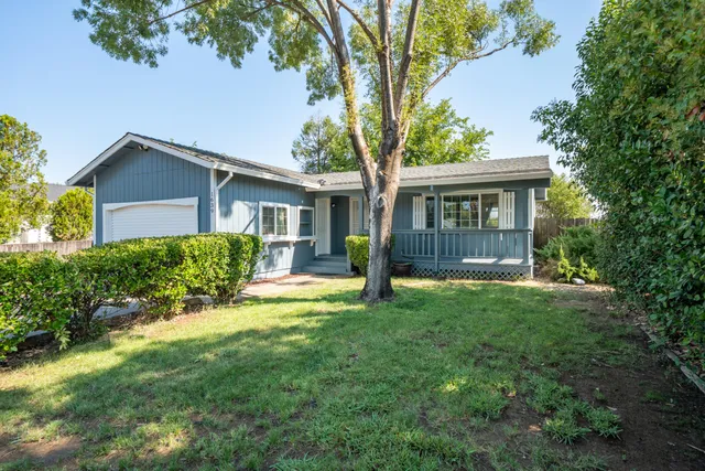 a view of an house with backyard space and garden