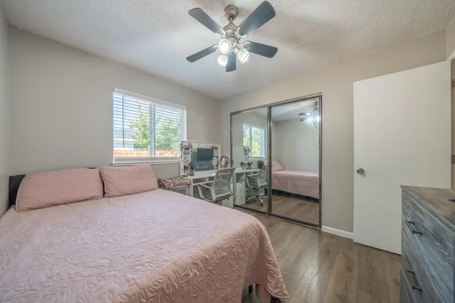 a bedroom with a large bed and a chandelier