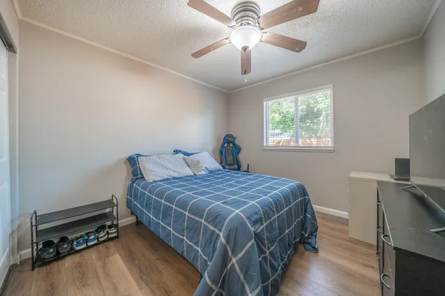 a bedroom with a bed and a chandelier