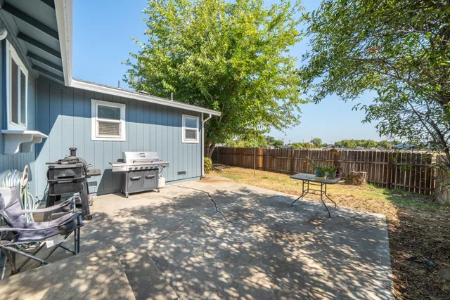a view of a backyard with sitting area