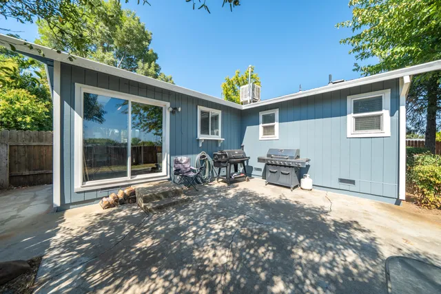 a view of a backyard with a patio and outdoor seating