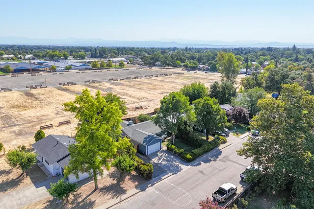 an aerial view of beach and residential houses with outdoor space