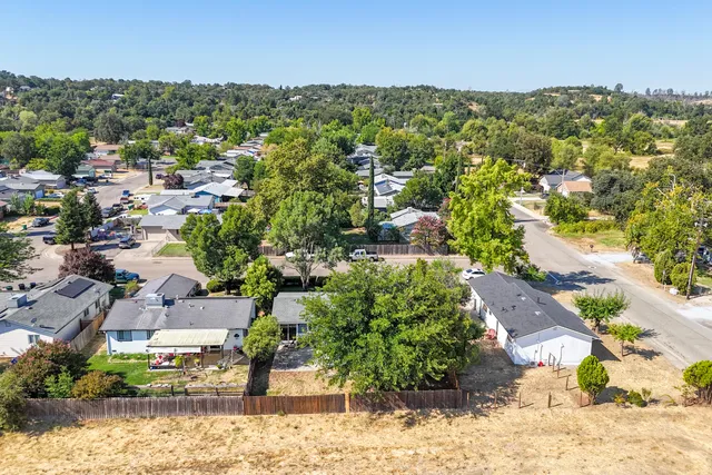 an aerial view of a house with a yard and garden