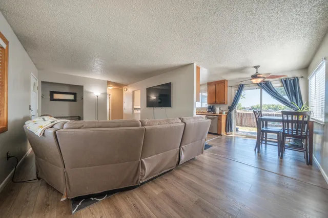 a living room with furniture and a wooden floor
