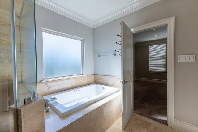 a bathroom with a tub and shower
