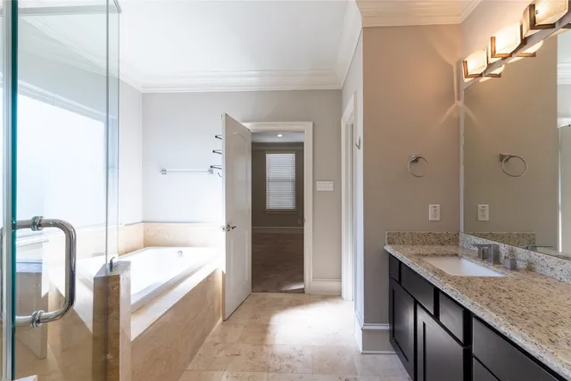 a bathroom with a granite countertop tub sink and mirror