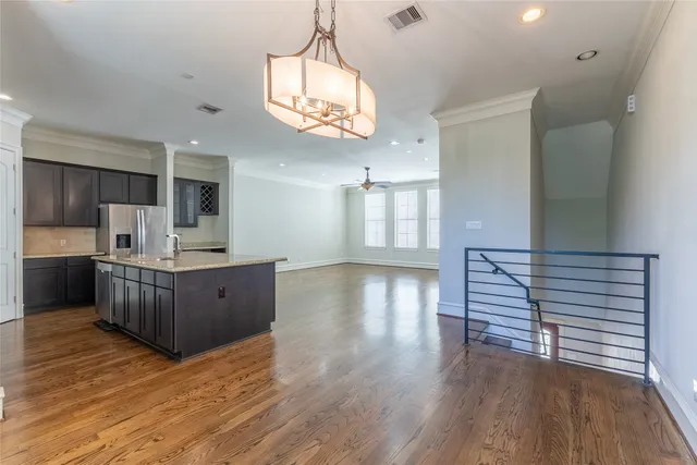 a kitchen with stainless steel appliances granite countertop a stove and wooden floor