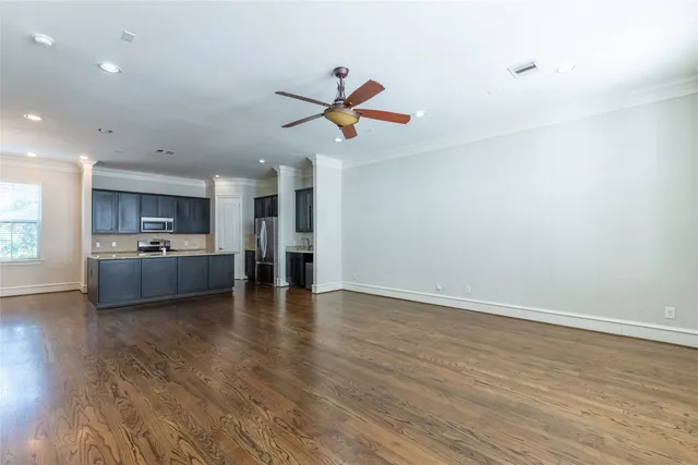 a view of a kitchen with a sink and dishwasher a refrigerator with wooden floor
