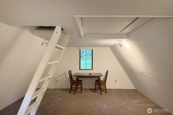 a view of a room with wooden floor and furniture