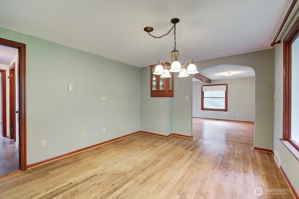 a view of a room with wooden floor chandelier and entryway