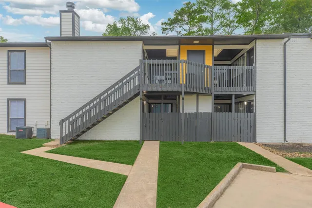 a view of house with backyard and deck