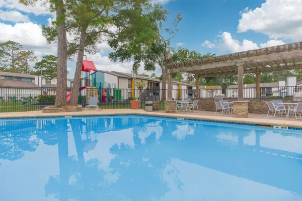 a view of swimming pool with outdoor seating and city view
