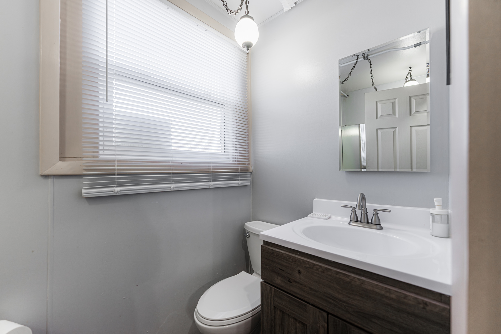 3432 Huffman Boulevard Rockford, IL 61103 - Photo 20 of 32 a bathroom with a sink a toilet and mirror
