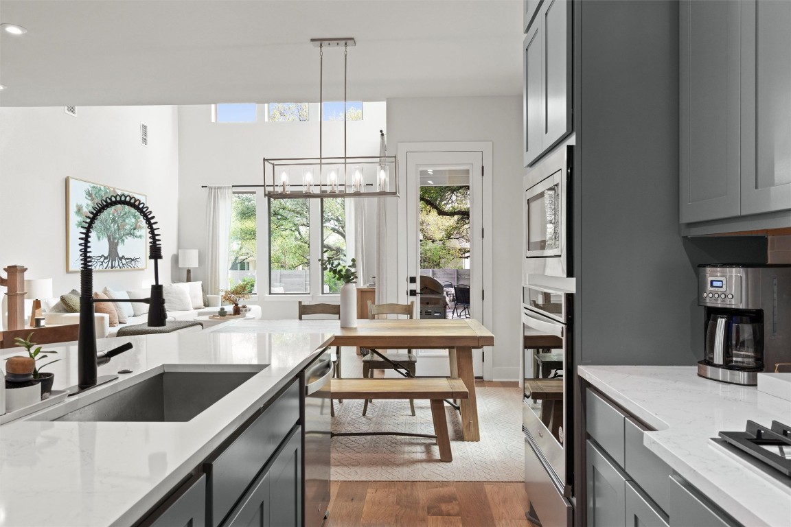 Bright and open kitchen with expansive island and natural light pouring in from the backyard views.
