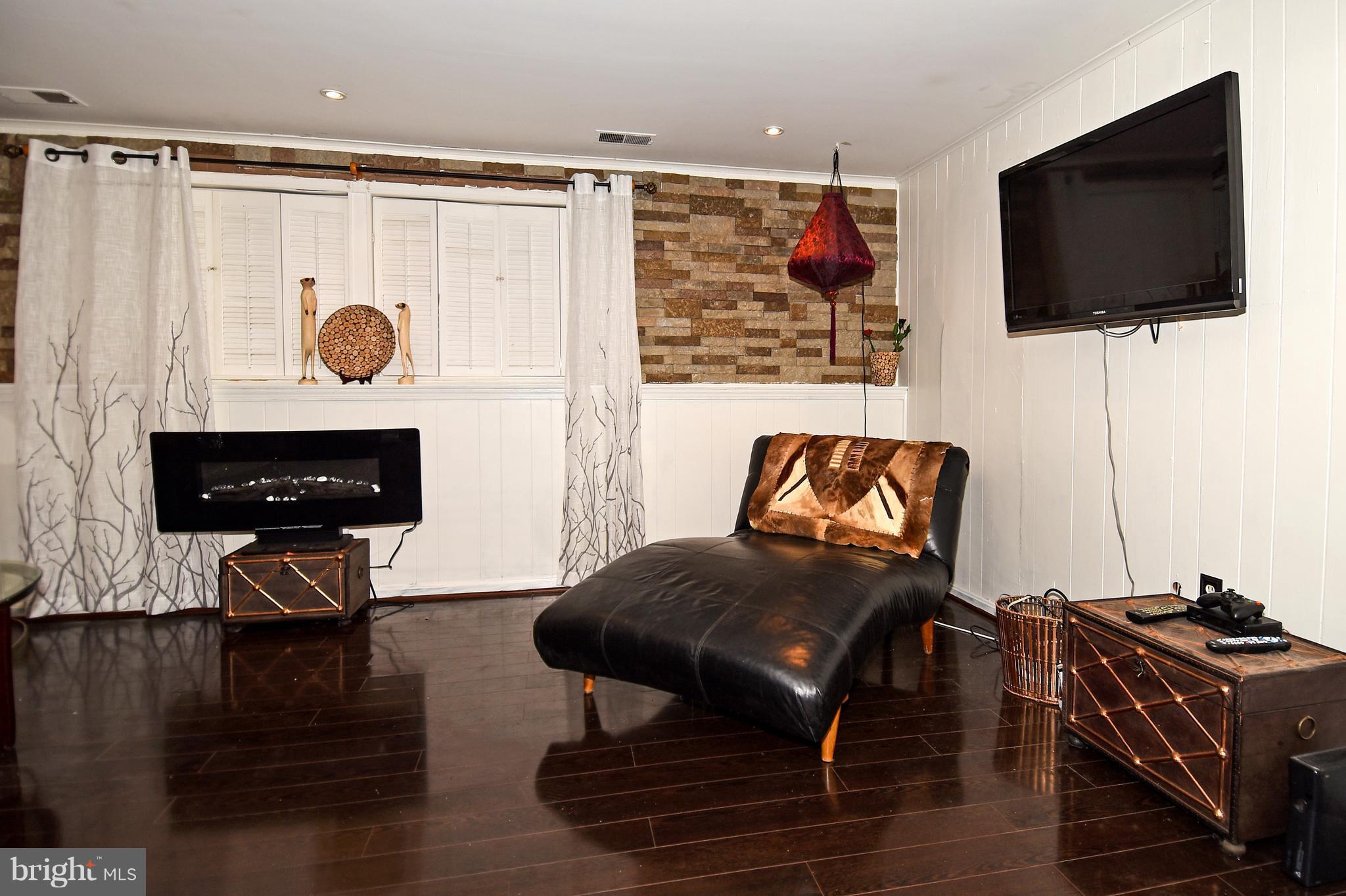 12917 Sturbridge Road Woodbridge, VA 22192 - Photo 18 of 29 Lower level rec room/den with hardwood floors.