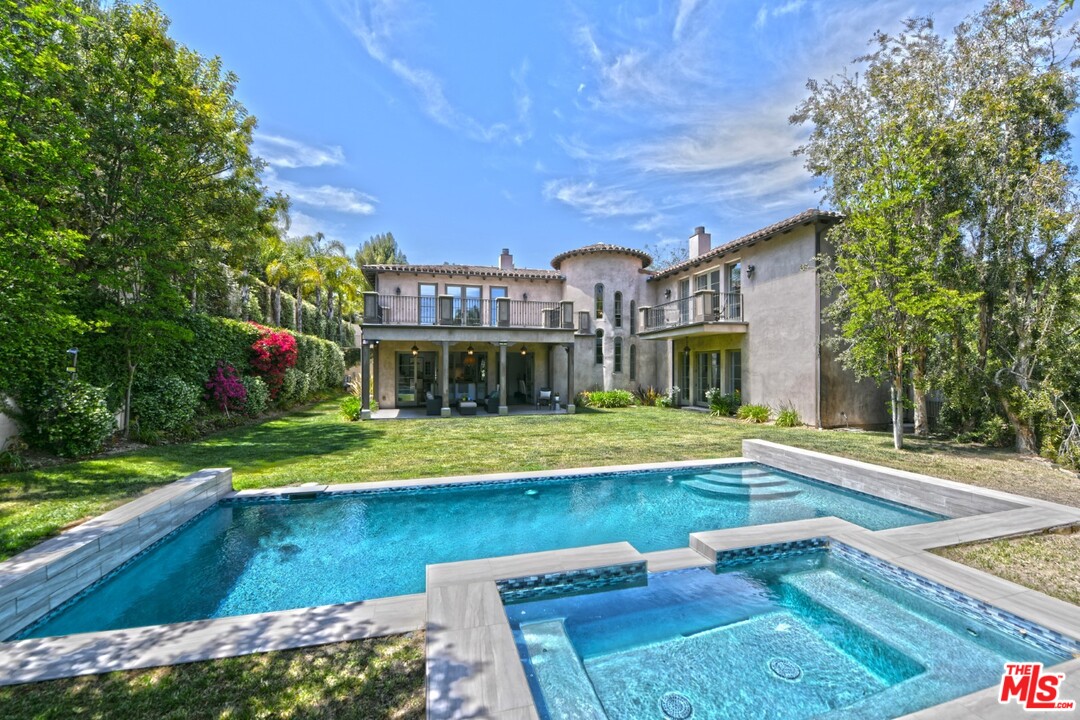 a view of a house with swimming pool and sitting area