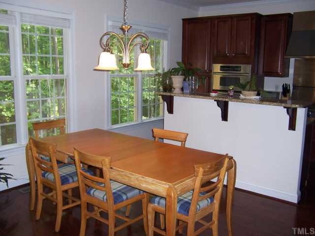 12708 Amoretto Way Raleigh, NC 27613 - Photo 7 of 12 Breakfast room looks out onto private wooded lot.