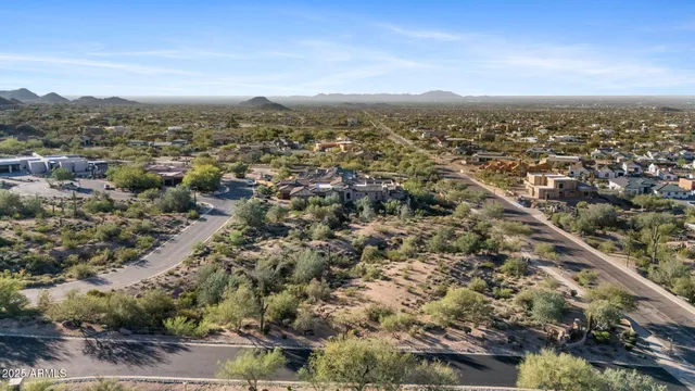 an aerial view of residential houses with city view