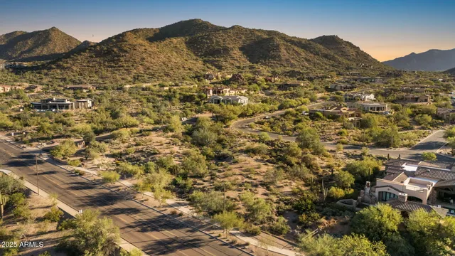 an aerial view of residential houses with city view