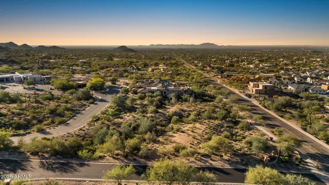 an aerial view of residential houses with city view