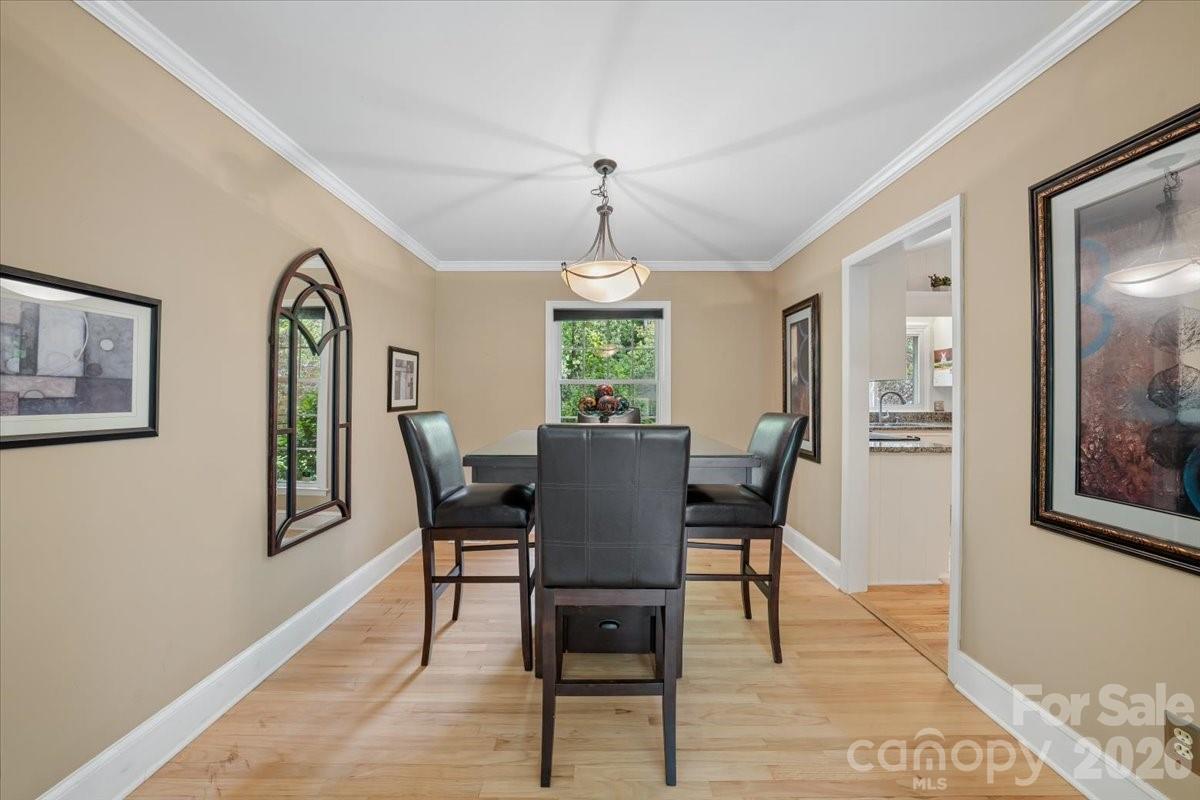 6701 Ronda Avenue Charlotte, NC 28211 - Photo 15 of 46 a view of a dining room with furniture window and wooden floor