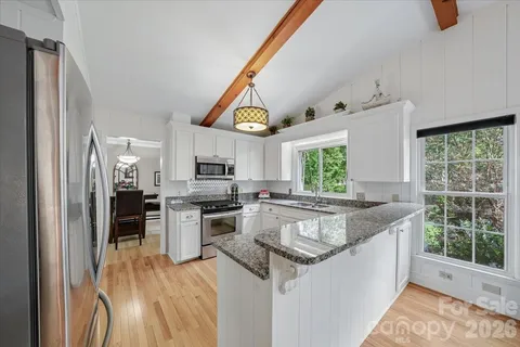 a kitchen with stainless steel appliances granite countertop a stove and a sink