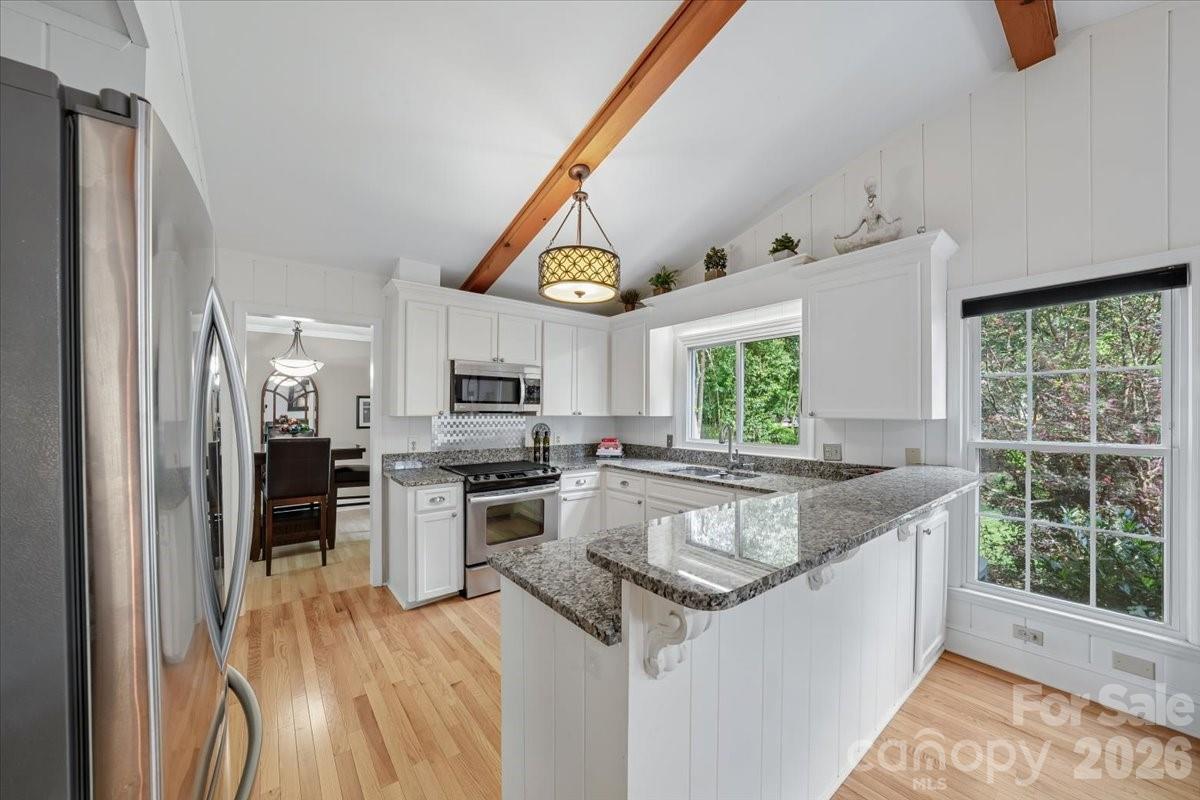 6701 Ronda Avenue Charlotte, NC 28211 - Photo 23 of 46 a kitchen with stainless steel appliances granite countertop a stove and a sink