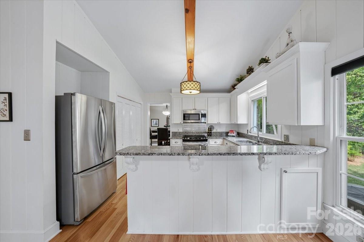 6701 Ronda Avenue Charlotte, NC 28211 - Photo 24 of 46 a kitchen with stainless steel appliances granite countertop a sink a refrigerator and a stove