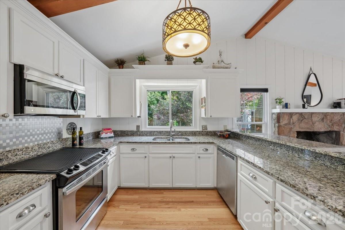 6701 Ronda Avenue Charlotte, NC 28211 - Photo 26 of 46 a kitchen with a sink stove and microwave
