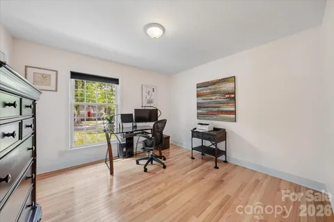 a view of a workspace with furniture and a window