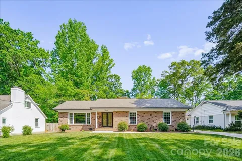 a view of house with yard and green space
